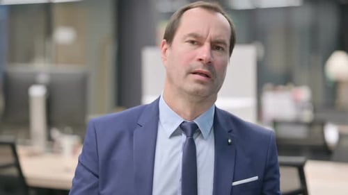 Mature Adult in Office Looking Concerned