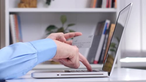 Man Doing Online Shopping Via Silver Card. Close Up