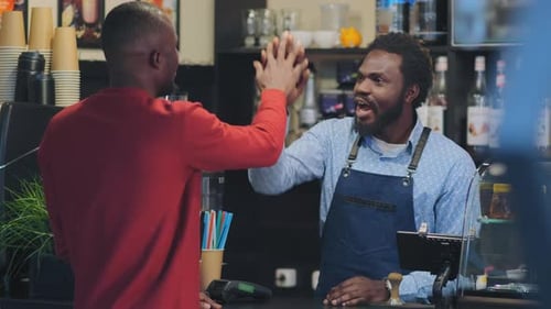 Black Man Stands Behind Bar Counter Talk and Smile