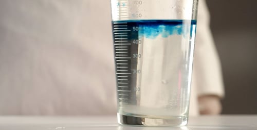 Blue Liquid Mixing in a Graduated Cylinder