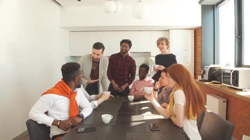 Colleagues Discussing at Conference Table in Office