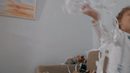Little boy having good time at paper party
