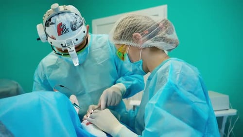Team of surgeons doing plastic surgery in modern clinic