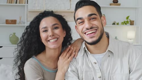 Happy Couple Waving During a Video Call