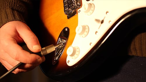 Electric Guitar Being Plugged In Close Up
