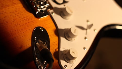 Guitar Controls Adjustment and Cable Plugging Close Up