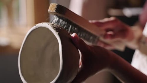 Refining Ceramic Vase with Brush