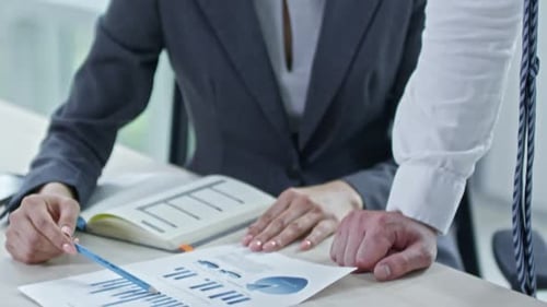 Business Professionals Collaborating on Data Analysis in Office