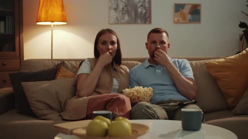 Couple Watching Horror Movie and Getting Scared