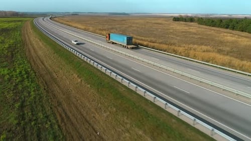 Trucks and Cars Go Along the Highway