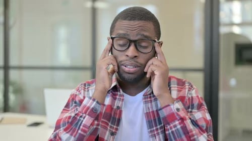 Young Adult Massaging Temples due to Headache