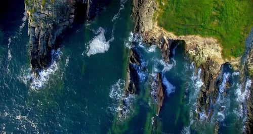 Dramatic Aerial View of Rocky Coastline and Crashing Waves