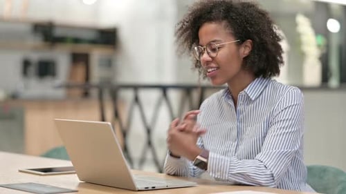Happy African Businesswoman Doing Video Call on Laptop in Office