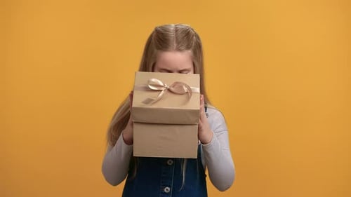 Unhappy Girl Holding Birthday Gift Box Present