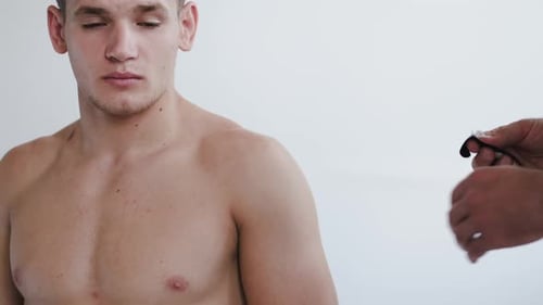 Portrait of Athlete Receiving Kinesiology Tape Therapy in Clinic