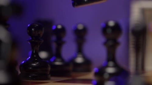 Hand Places Black Knight on Chess Board