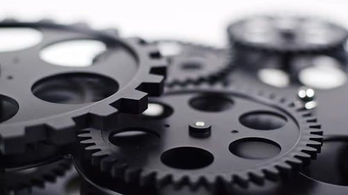 Black Cogwheels Meshing Together Close Up