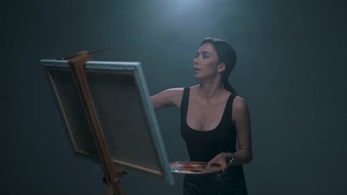 Female Artist Painting on Canvas in Studio