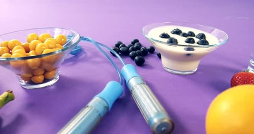 Healthy Food and Exercise Gear on Purple Table