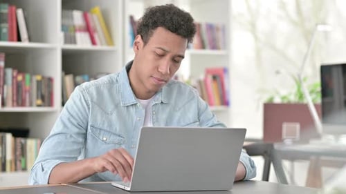 Man Working on Laptop at Home