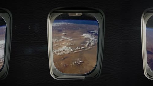 Flying Over Earth from Space through Airplane Window