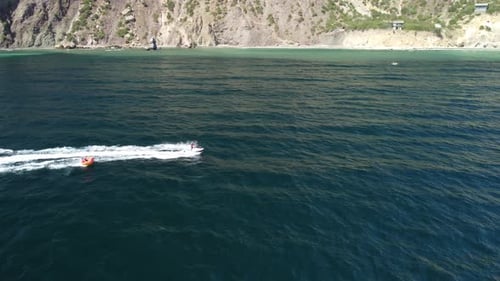 Jet Ski Pulling Tube in Ocean, Aerial View