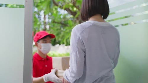 Woman Receives Packages from Delivery Service at Door