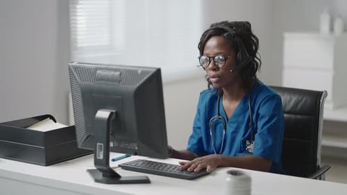 Woman Doctor Telemedicine on Computer with Headset