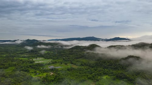 Flying through the clouds above the mountain peak.
