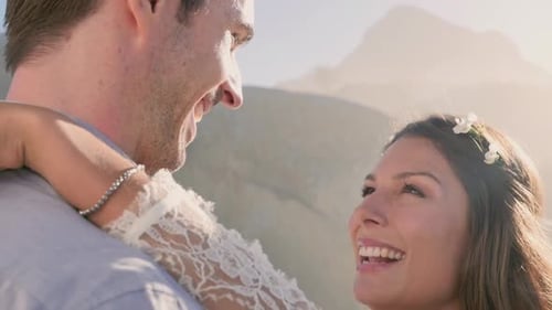 Loving Couple Embrace on Sandy Beach at Daytime