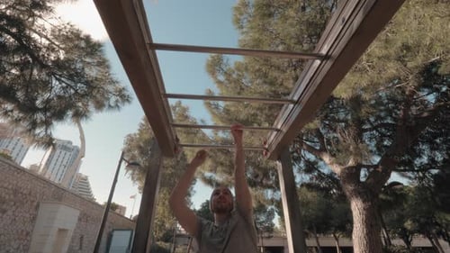 A Young Man Doing a Monkey Bar Walk