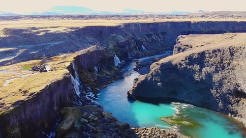 Majestic canyon with river and waterfalls