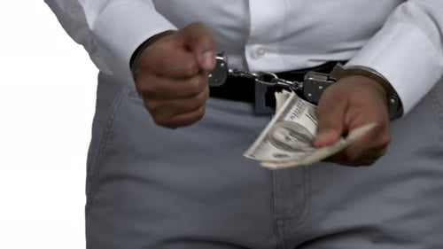 Man in Handcuffs Holding Money Close Up