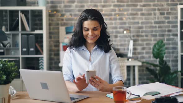 Woman Using Phone While Working at Desk, People Stock Footage ft. woman ...