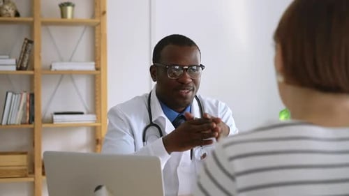 Doctor Consulting With Patient at Medical Office