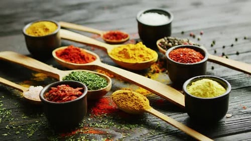 Assorted Spices and Herbs Arranged on a Dark Surface
