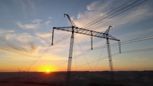 High Voltage Tower with Electric Power Lines at Sunset