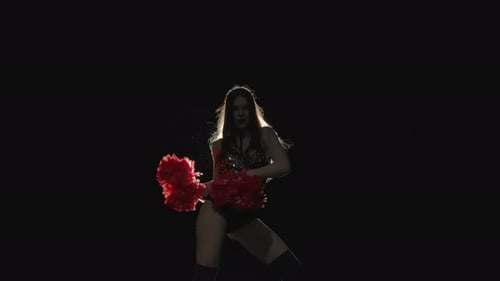 Young Adult Woman Dancing with Pom Poms in Studio