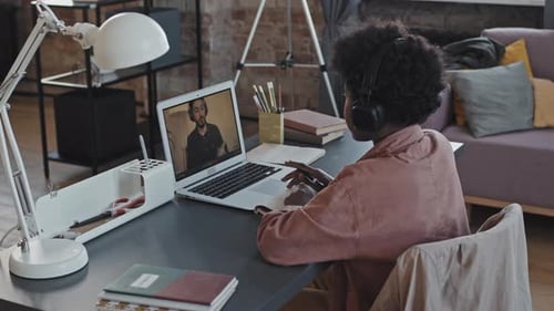 Person Attends Online Class at Home Office