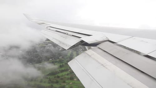 Airplane flying through clouds seconds before touching down