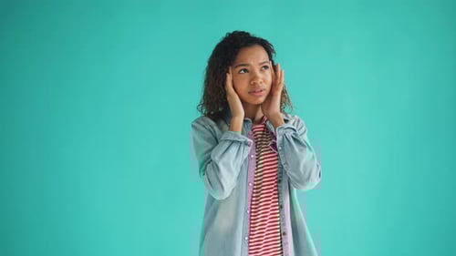Young Woman Experiencing Headache in Studio