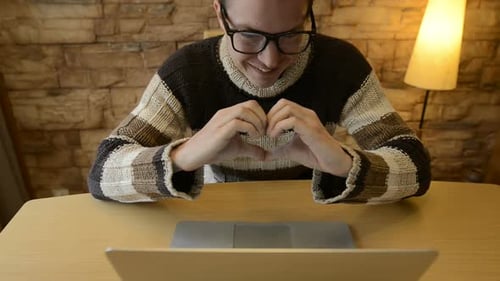 Adult Working on Laptop at Desk Indoors