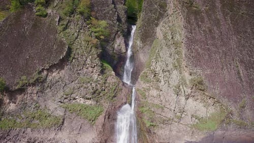 Powerful waterfall between huge rocks