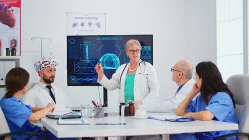 Medical Team Discusses Brain Scan in Meeting