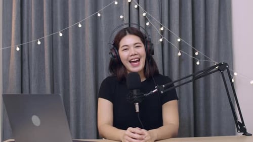 Young Adult Woman Recording Podcast at Home