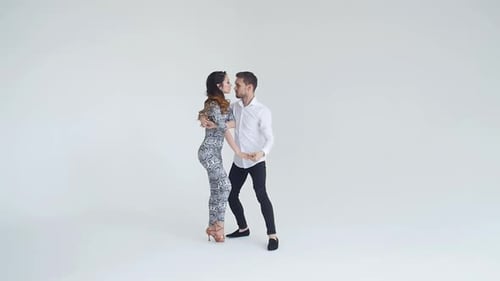 Elegant Couple Dancing Together in White Studio