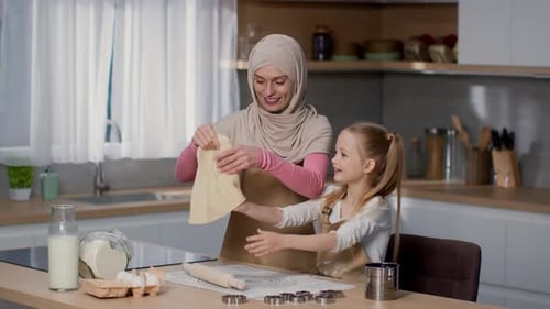 Woman and Child Cooking Together in Kitchen