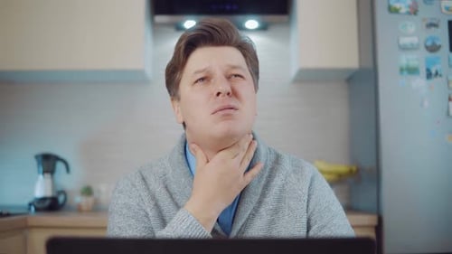 Adult Man with a Sore Throat in Home