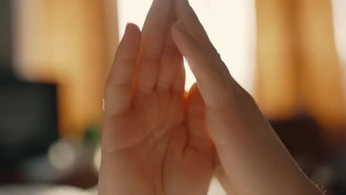 Close up of hands rubbing together indoors