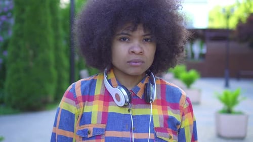 Portrait Sad African American Woman with an Afro Hairstyle on the Street